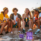 Friends using a JBL Go speaker with the open purple and orange travel case at the beach