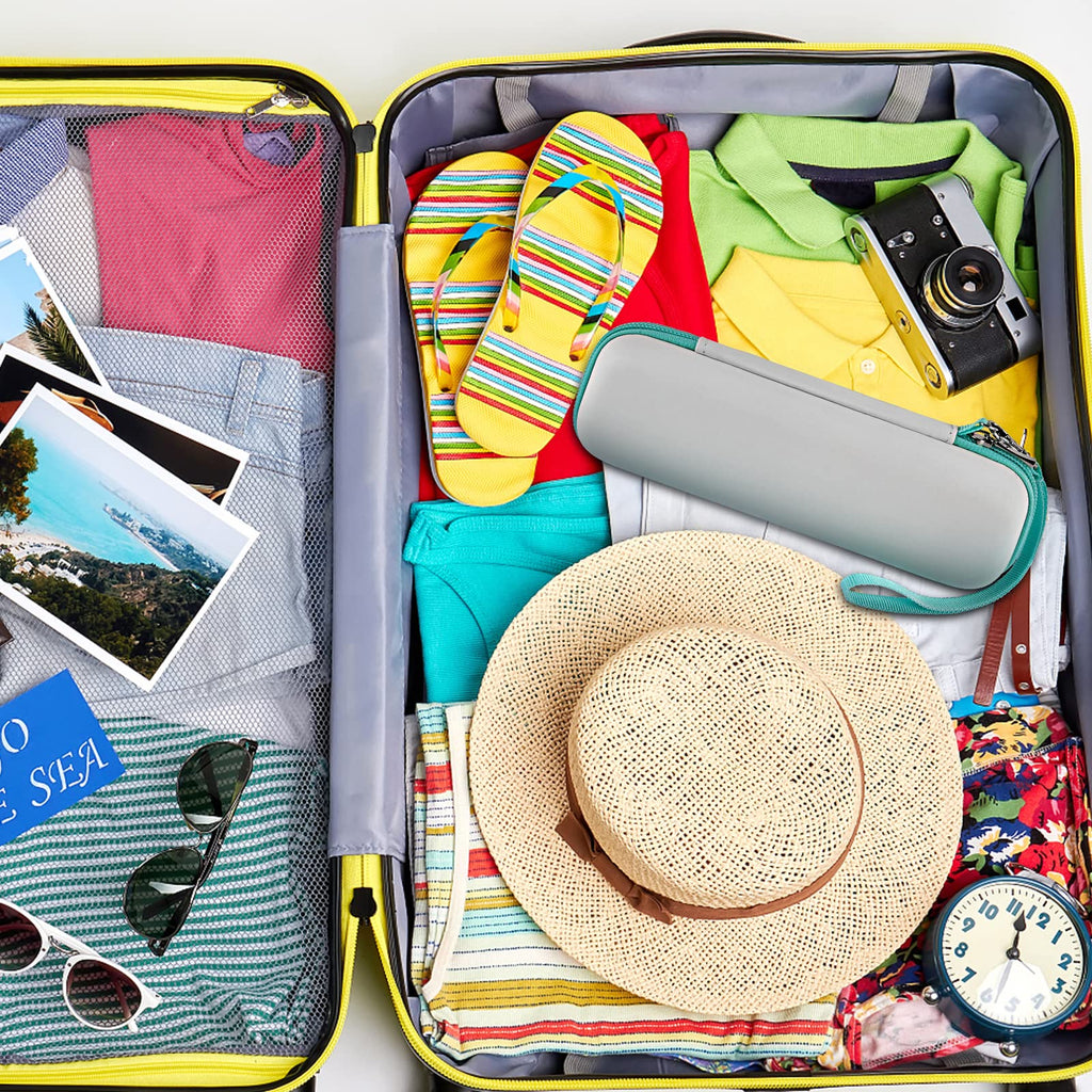 Teal electric toothbrush case packed inside a suitcase